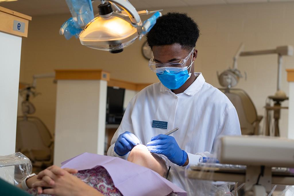 a student works on a patient in the dental hygiene clinic