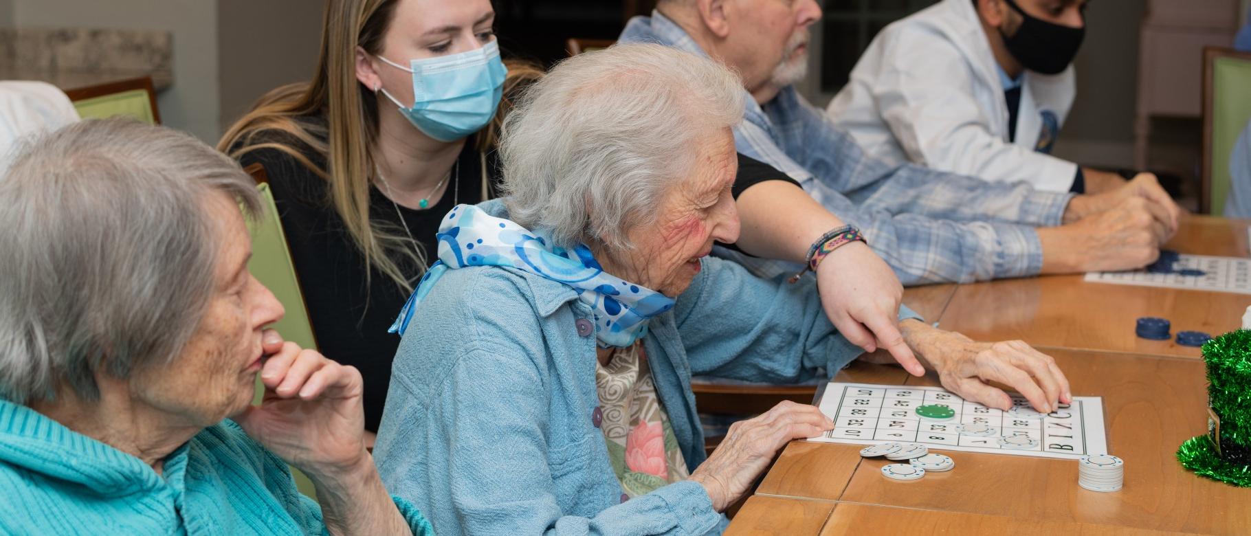 UNE health professions students play bingo with seniors at an assisted living facility