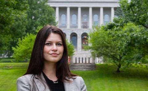 Image of Kiara Frischkorn posing for portrait in front of Maine State House